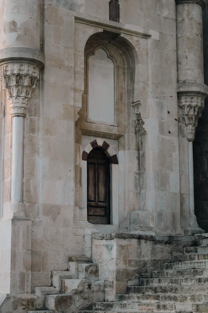 Detailed shot of an ornate historical church facade featuring columns and stone steps.